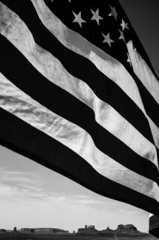 Terry LaRue, Flag over Monument Valley #2, Utah, Photograph, 24 × 20in. (61 × 50.8cm), Courtesy of the artist, Seattle, Washington